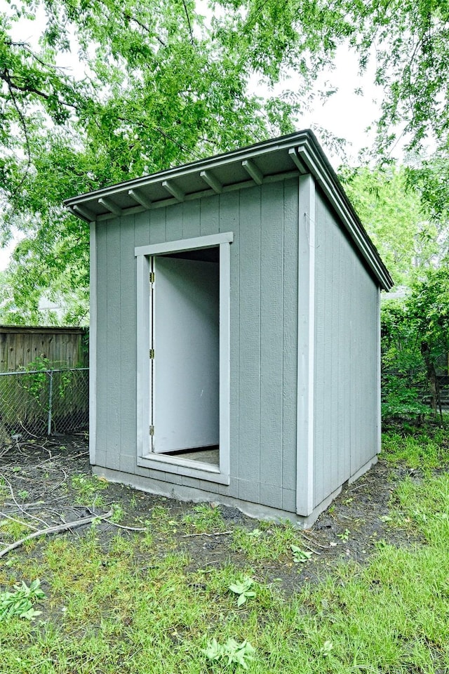 view of shed featuring fence
