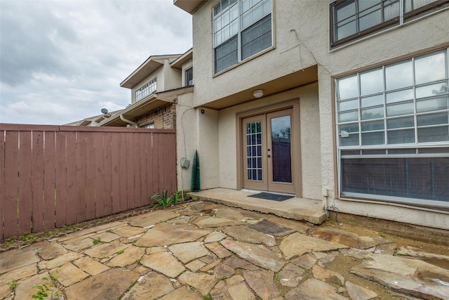 view of patio featuring fence and french doors