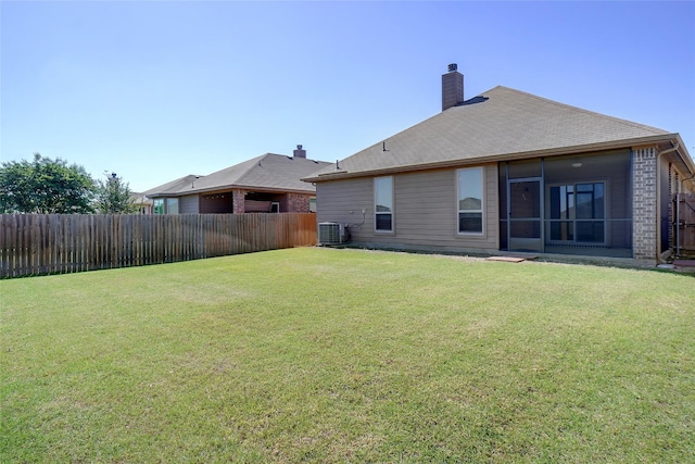1441 Elkford Ln, Fort Worth, TX 76247 - rear view of property with a chimney, a sunroom, brick siding, and central AC