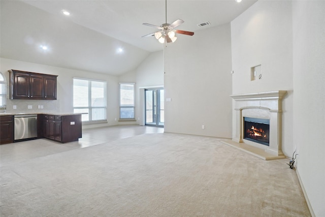1441 Elkford Ln, Fort Worth, TX 76247 - unfurnished living room with high vaulted ceiling, a ceiling fan, a warm lit fireplace, light colored carpet, and recessed lighting