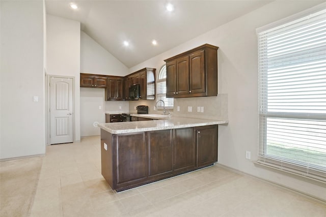 1441 Elkford Ln, Fort Worth, TX 76247 - kitchen featuring black appliances, a peninsula, dark brown cabinets, a sink, and light tile patterned floors