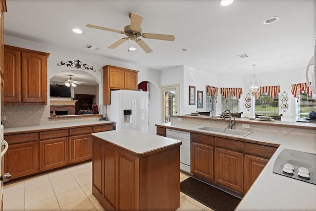 125 Deer Stream Ct, Azle, TX 76020 - kitchen featuring a sink, ceiling fan, light countertops, arched walkways, and white appliances