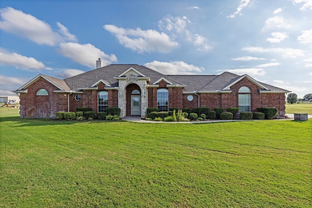 125 Deer Stream Ct, Azle, TX 76020 - ranch-style house with a front yard, roof with shingles, brick siding, and a chimney