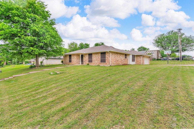 ranch-style house with brick siding, a front yard, and a garage