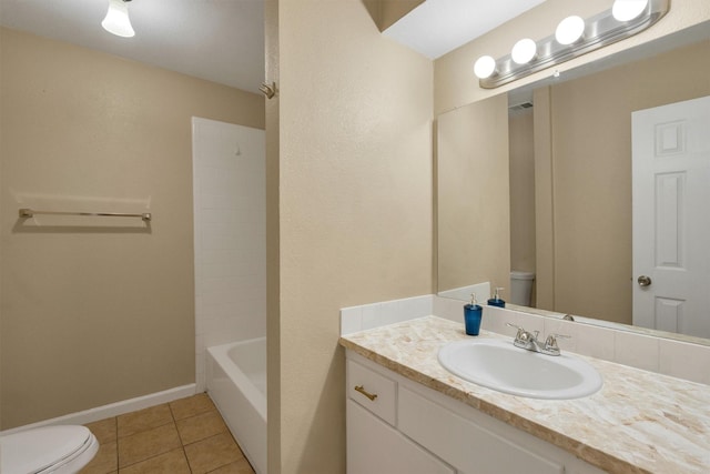 bathroom featuring tile patterned flooring, baseboards, toilet, and vanity