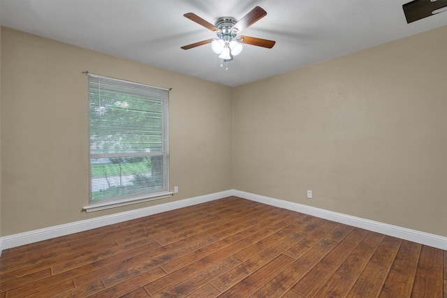 empty room featuring baseboards, a ceiling fan, and wood finished floors