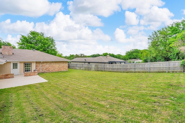 view of yard with a fenced backyard and a patio area