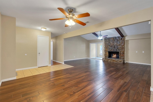 unfurnished living room featuring visible vents, ceiling fan, wood finished floors, and beamed ceiling