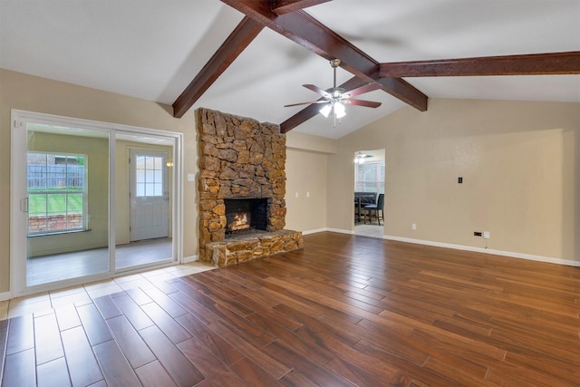 unfurnished living room with a stone fireplace, a ceiling fan, and wood finished floors