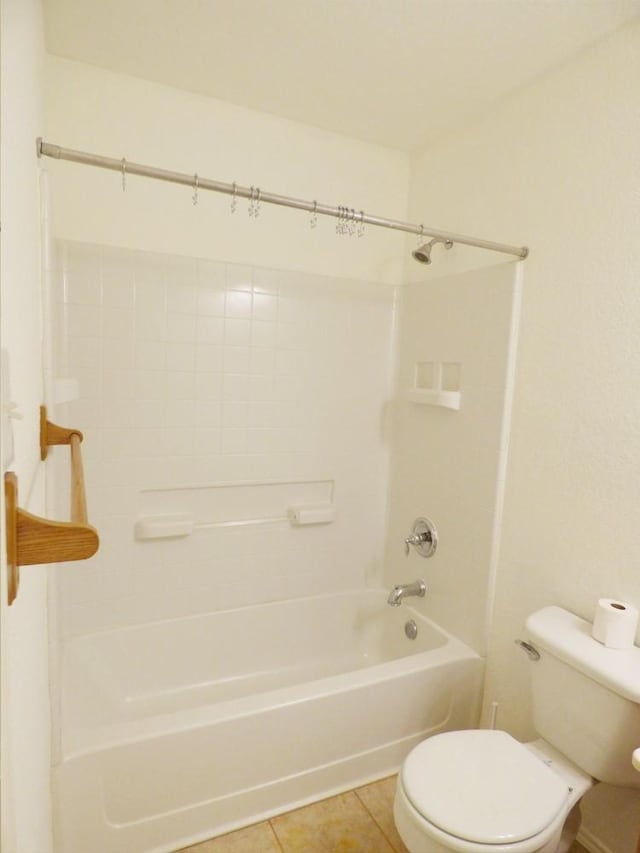 full bath with toilet, tile patterned flooring, and shower / bath combination