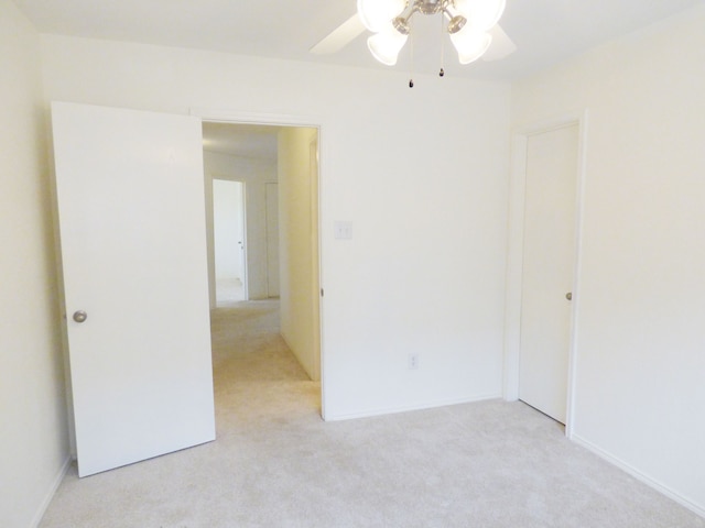 empty room with light colored carpet and ceiling fan