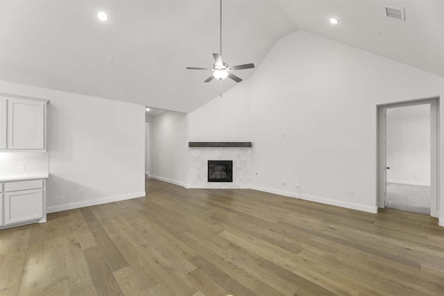 3505 Paintbrush Path, Melissa, TX 75454 - unfurnished living room featuring high vaulted ceiling, visible vents, ceiling fan, light wood-style flooring, and a glass covered fireplace