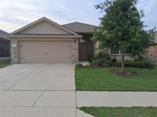 ranch-style house featuring concrete driveway, a front yard, an attached garage, and brick siding