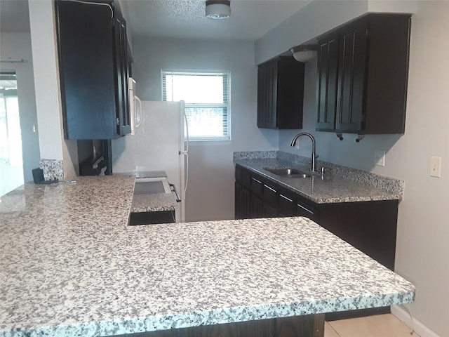 kitchen featuring light countertops and a sink