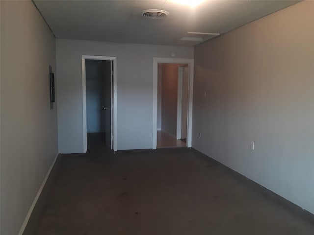 interior space with visible vents and dark colored carpet