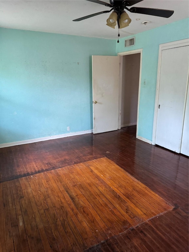 unfurnished bedroom featuring visible vents, ceiling fan, hardwood / wood-style flooring, and baseboards