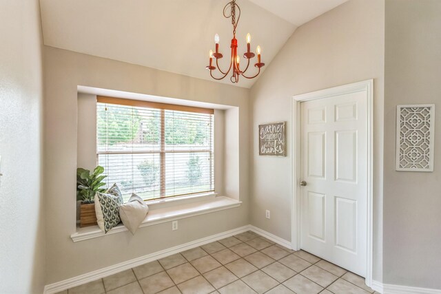 interior space with light tile patterned flooring, a notable chandelier, lofted ceiling, and baseboards