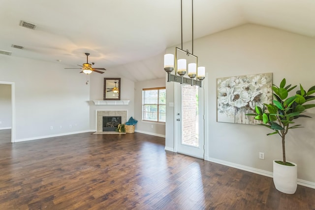 unfurnished living room with a tile fireplace, visible vents, ceiling fan, and lofted ceiling
