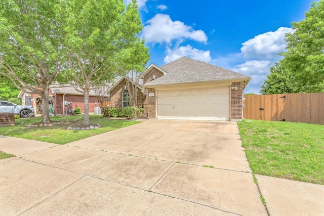 view of front of property featuring a gate, roof with shingles, a front yard, fence, and brick siding