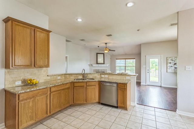 kitchen with a sink, decorative backsplash, a ceiling fan, a peninsula, and dishwasher