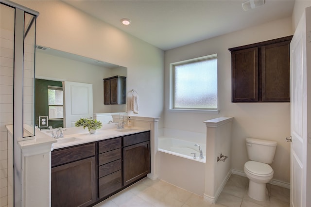 full bath featuring a garden tub, visible vents, double vanity, toilet, and a sink