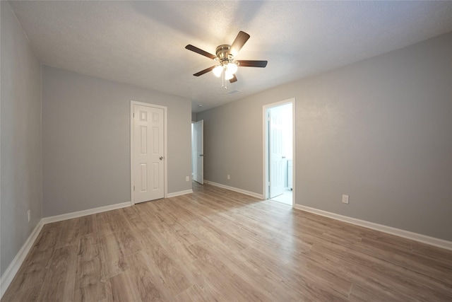1121 Stone Trail Dr, Plano, TX 75023 - empty room featuring a ceiling fan, light wood-style floors, and baseboards