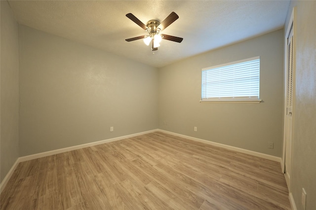 1121 Stone Trail Dr, Plano, TX 75023 - unfurnished room with light wood finished floors, a ceiling fan, baseboards, and a textured ceiling