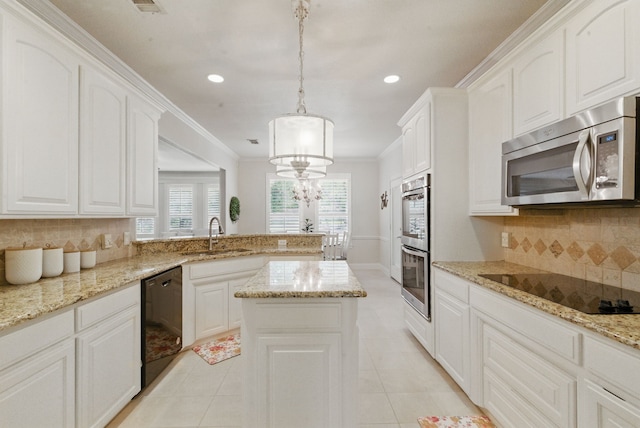 kitchen with light tile patterned floors, decorative backsplash, a sink, black appliances, and a peninsula