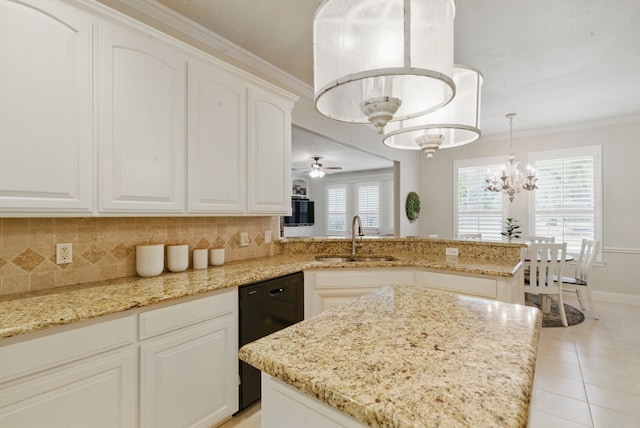 kitchen with black dishwasher, backsplash, a sink, and a wealth of natural light