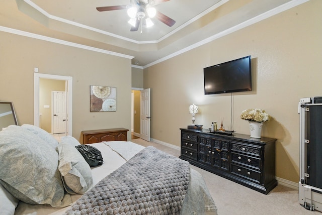 bedroom with ornamental molding, a raised ceiling, carpet floors, and baseboards