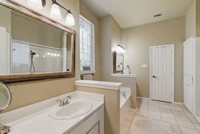 bathroom featuring vanity, walk in shower, tile patterned floors, visible vents, and a garden tub