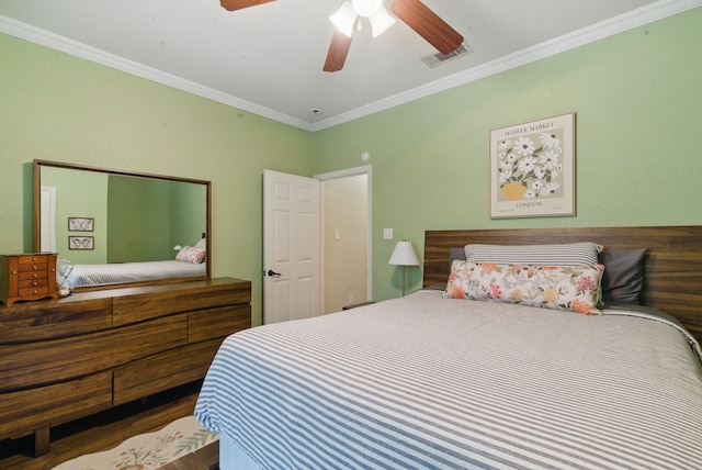 bedroom with ornamental molding, a ceiling fan, and visible vents