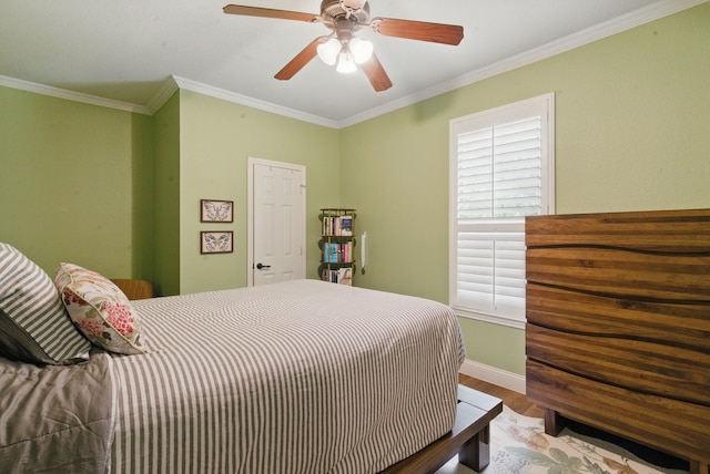 bedroom with wood finished floors, crown molding, a ceiling fan, and baseboards