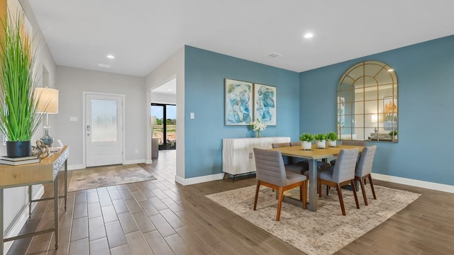 dining area with wood finished floors, recessed lighting, visible vents, and baseboards