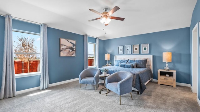 carpeted bedroom featuring ceiling fan, vaulted ceiling, and baseboards