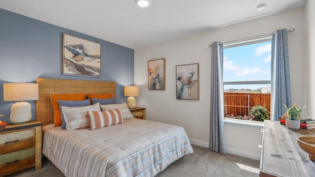 carpeted bedroom featuring baseboards