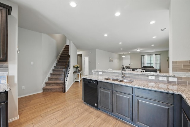 6309 Outrigger Rd, Fort Worth, TX 76179 - kitchen with a sink, black dishwasher, light wood finished floors, recessed lighting, and light stone counters