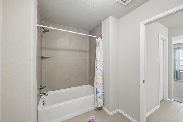 6309 Outrigger Rd, Fort Worth, TX 76179 - bathroom featuring tile patterned floors, shower / bath combo with shower curtain, baseboards, and a textured ceiling
