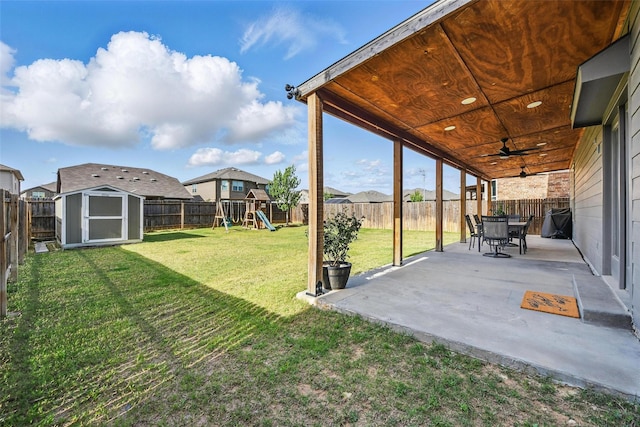 6309 Outrigger Rd, Fort Worth, TX 76179 - view of yard featuring a playground, a shed, a patio, ceiling fan, and an outbuilding