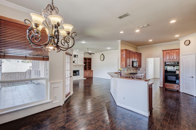 kitchen with decorative backsplash, dark wood-style floors, black appliances, recessed lighting, and ceiling fan with notable chandelier