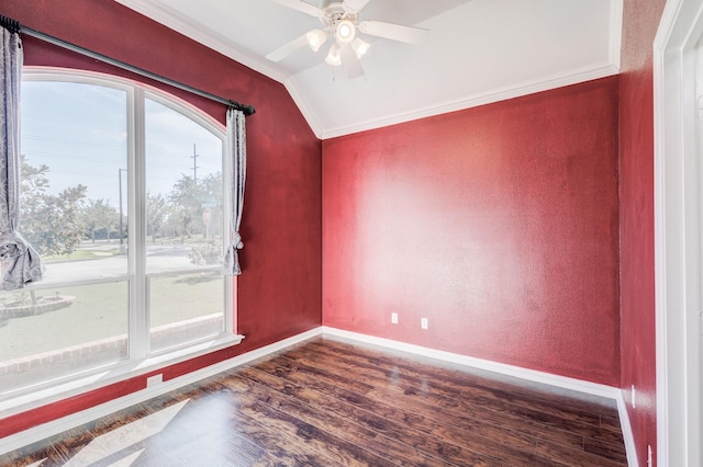empty room with crown molding, ceiling fan, baseboards, dark wood-style flooring, and vaulted ceiling