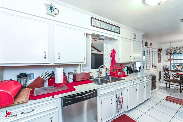 kitchen with light tile patterned floors, stainless steel dishwasher, white cabinets, a sink, and light countertops