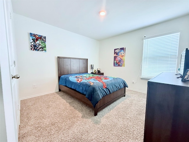 carpeted bedroom featuring baseboards