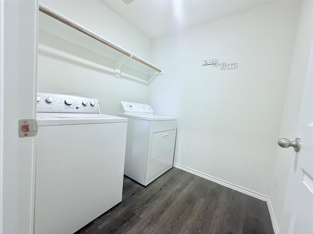 laundry room featuring laundry area, dark wood-type flooring, baseboards, and independent washer and dryer