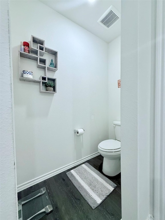 2802 Elk Rd, Crandall, TX 75114 - bathroom with toilet, wood finished floors, and baseboards