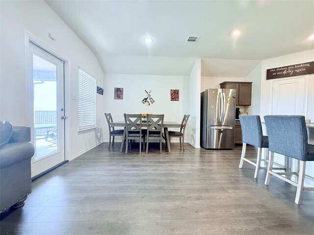 dining room featuring visible vents, plenty of natural light, and wood finished floors