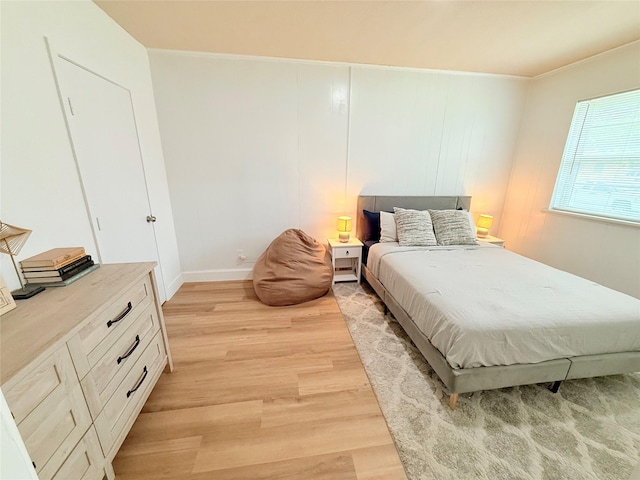 bedroom with baseboards and light wood-style floors