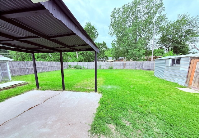 view of yard with a patio, a fenced backyard, an outbuilding, and a storage shed