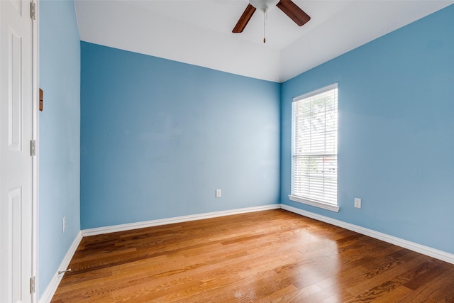 unfurnished room featuring baseboards, a ceiling fan, and wood finished floors