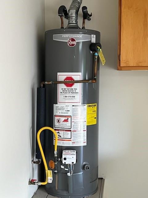 utility room featuring gas water heater